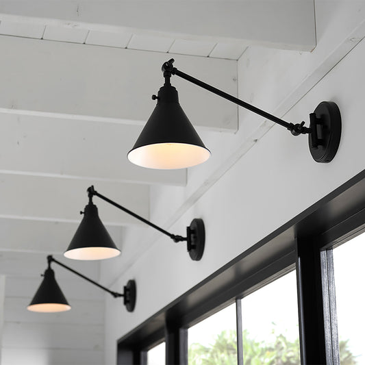 Arti Swing-Arm Metal Wall Sconce by Hinkley in a styled interior
