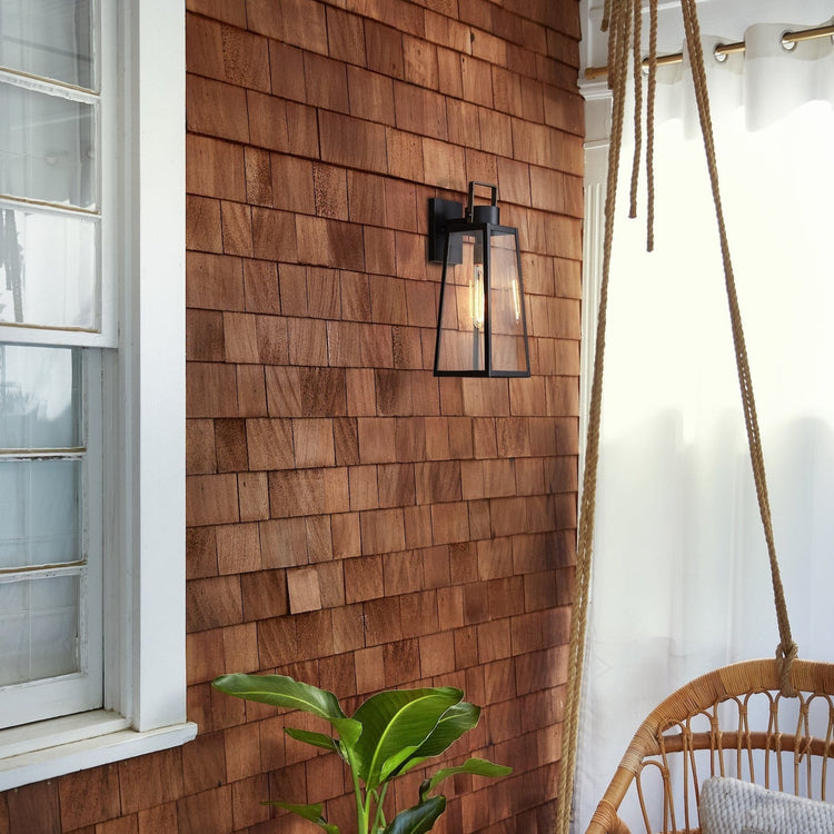 Black exterior wall lantern on a cedar-shingle wall