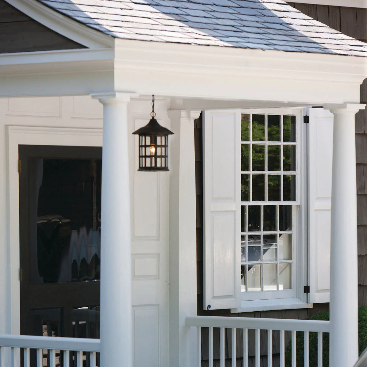 Freeport Exterior Hanging Lantern by Hinkley in Oil Rubbed Bronze, shown on a home exterior