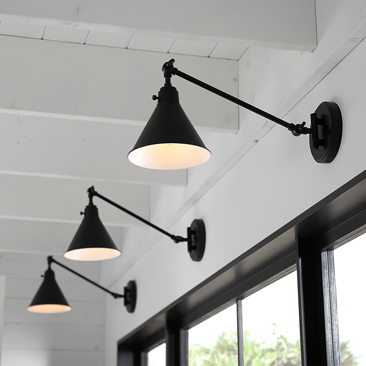 Arti Swing-Arm Metal Wall Sconce by Hinkley in a styled interior