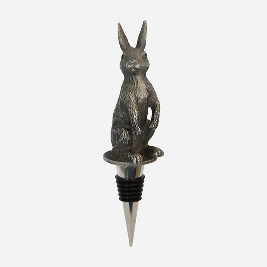 Metallic rabbit-shaped bottle stopper on a white background