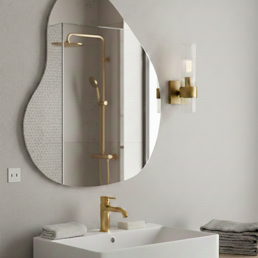 Geneva Wall Sconce by Visual Comfort in Burnished Brass, shown in a styled interior