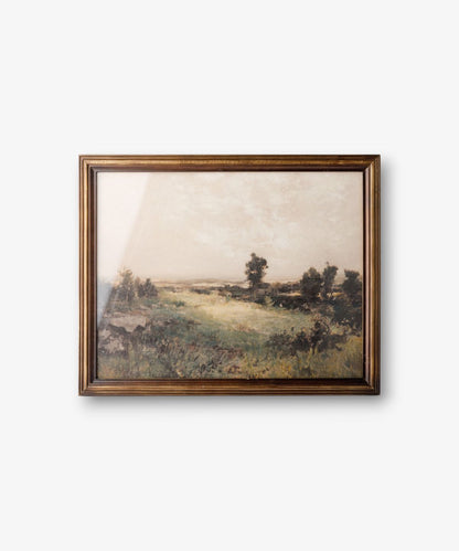 Framed landscape painting on a white wall