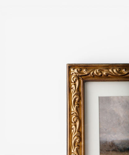 Decorative gold frame on a white wall